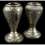 A pair of Middle Eastern white metal vases, each decorated with figures within lozenges, geometric