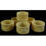 A set of six early 20thC Chinese Canton type ivory napkin rings, each decorated with the dragon,