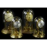 Four brass and brass effect anniversary type clocks, to include an example stamped Kundo, another