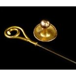 Two items of jewellery, to include a 9ct gold cufflink, and a hat pin, with yellow metal scroll