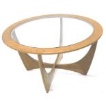 A G-plan retro style circular coffee table, with a smoked glass insert, 84cm dia.