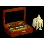 A late 19th/early 20thC Indian ivory carving, in the form of gentleman seated on elephant, 5cm L,