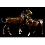 A Beswick model of a brown horse, with one leg raised and another brown horse. (2)