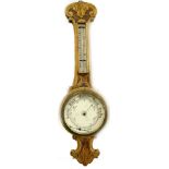 A late Victorian aneroid wheel barometer, in carved oak case (AF), 86cm H.