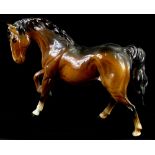 A Beswick brown model of a horse, with one raised leg, 18cm H.