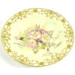 A Royal Crown Derby porcelain plate, painted with flowers within a gilt border, attributed to F.