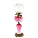 A Victorian pink opaque glass oil lamp, the Art Nouveau style frosted shade decorated with