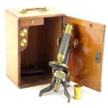 A T and H Doublet brass microscope, with various fittings in a fitted teak case, 17cm H.