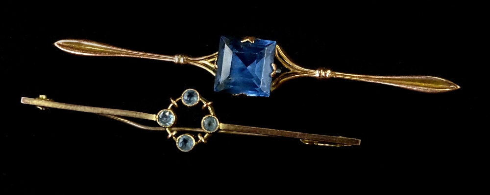 Two bar brooches, comprising a 9ct bar brooch of circular design set with four aquamarines, 5.5cm