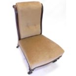 A Victorian walnut nursing chair, with a button back padded seat, on turned tapering legs, with