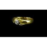 An 18ct gold diamond solitaire ring, the diamond in platinum rub over setting, with raised and waved