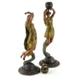 A pair of Continental painted spelter figures, each modelled in the form of a neo-classical lady,