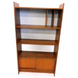 A 1970's/80's retro style teak bookcase or record cabinet, with various shelves and two sliding