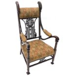 An Edwardian mahogany armchair, with a padded back, arm rests and seat, the back with pierced rails,