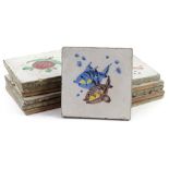 A set of twelve Continental tin glazed tiles, each decorated with fish, flowers etc., 20cm W.