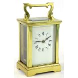 A French brass carriage timepiece, the white enamel dial with Roman Numerals, 15cm H.Provenance: