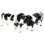 A Beswick Fresian bull, a cow and a calf. (3)