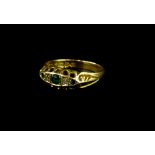 An 18ct gold emerald and diamond gypsy ring, with scroll design head, ring size N½, 2.5g all in.