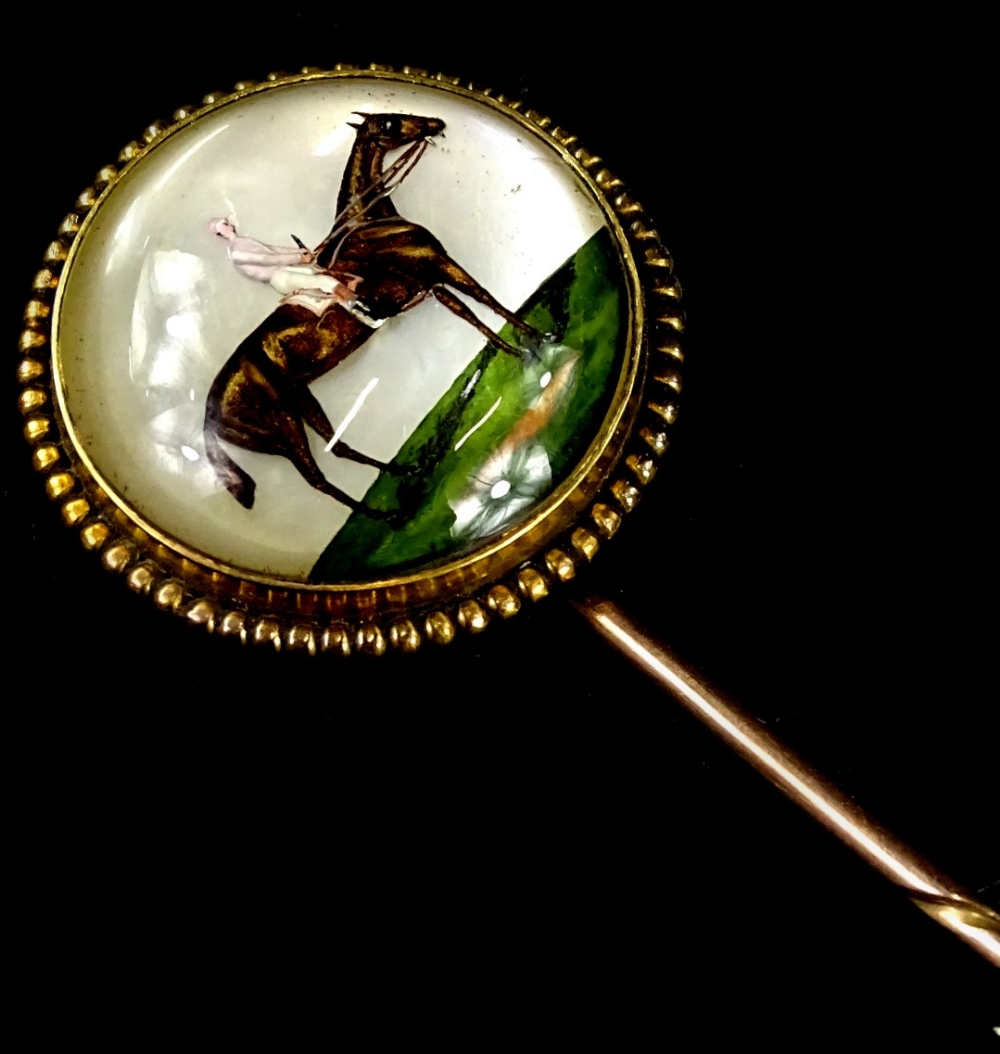 An Essex crystal stick pin, with circular pin head depicting a figure on horseback, 2cm dia, with