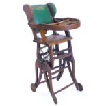 A Victorian ash adjustable child's chair, with green padded back, on castors. (AF)