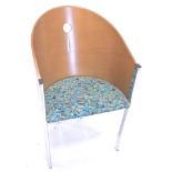 A retro style bentwood and chrome tub shaped chair, with pierced back, padded seat.The upholstery in