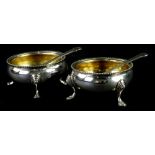 A pair of silver cauldron salts, each with a gilt interior and gadrooned edge, on three cabriole
