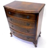 A walnut bow front chest of drawers in George III style, the top with a cross banded border and a