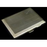 A George V silver rectangular cigarette box, with engine turned decoration and engraved with