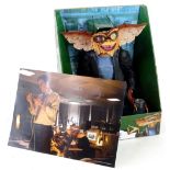 A Reel Toys gremlin model, a signed photograph of the star of Dragons Den Peter Jones, a prize