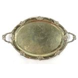 A Victorian silver plated tray, with shaped borders, two pierced handles engraved overall with