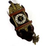 A Continental mahogany and brass wall clock, the raised top cast with a figure of Atlas,
