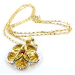 A 9ct gold pendant and chain, the floral pendant of pierced design with central garnet and cz