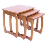 A nest of three retro style teak tables in the manner of 'G' plan, the largest 50cm W.