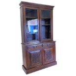 A Victorian walnut bookcase, the top with a moulded cornice with two glazed doors, the base with two