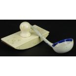 A late 19thC carved ivory desk blotter, and a pottery ladle.