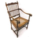 A 19thC Lancashire type spindle back ash Windsor type armchair, with a rush seat, on turned tapering