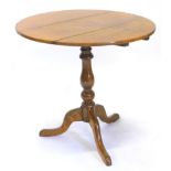 A 19thC oak occasional table, the circular tilt top on a turned column and tripod base, 76cm dia.