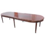 A large mahogany board room type table, the top with a moulded edge, above a stylised carved