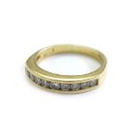 An 18ct gold half hoop diamond eternity ring, set with nine round brilliant cut diamonds, marked