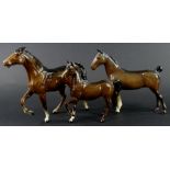 Three Beswick brown horses, to include two with raised legs, various sizes.