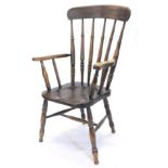 A 19thC beech ash and elm Windsor chair, with spindle turned back, shaped solid seat, on turned