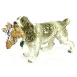 A Beswick style pottery model of a spaniel carrying a duck, 19cm H.