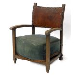 A stained beech child's chair, with a brown leather padded back and sprung cushion.