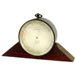 A 19thC barometer by J Hicks of London, numbered 5672, in a metal case with associated wooden stand,