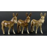 Three Beswick donkey foals, 12cm H.