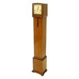 An Art Deco walnut grandmother type clock, with a cream and white painted dial, Westminster chime