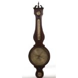 A early 19thC flamed mahogany wheel barometer, with swan neck pediment with urn finial, satinwood