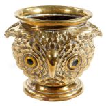A Victorian brass owl jardiniere, the eyes picked out in yellow and black with a feathered body,