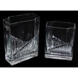 A graduated pair of 20thC Finnish glass Tapio Wirkkala vases, each in clear glass, partially cut,