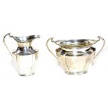 A George V silver two piece tea service, comprising of a milk jug and two handled sugar bowl, 11cm